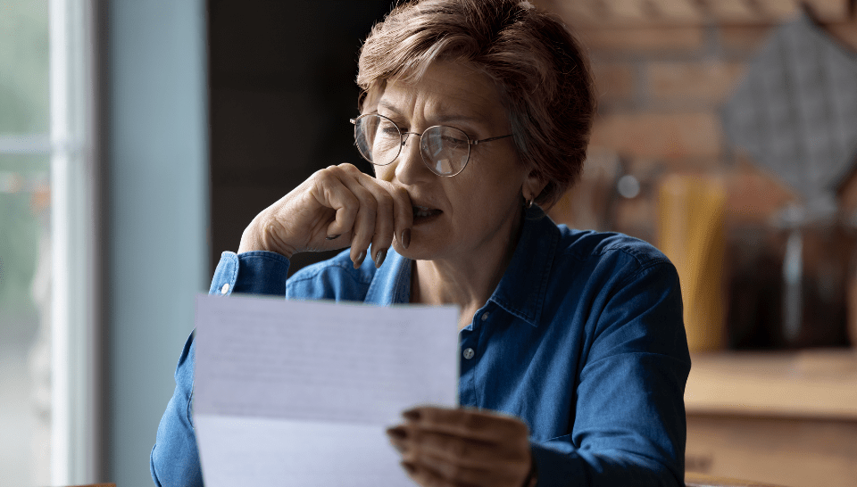 A woman reads a letter.