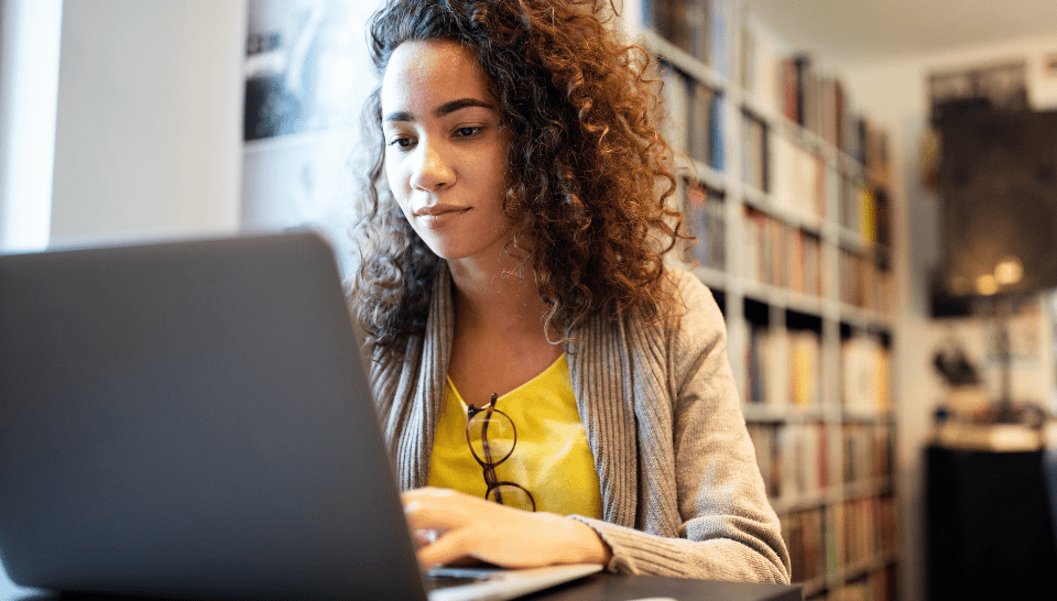 A woman works on a laptop.