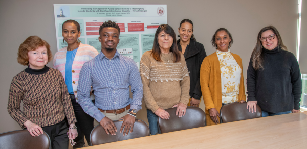 Members of the Educational Advocates Program team stand in a conference room at the Sherlock Center.