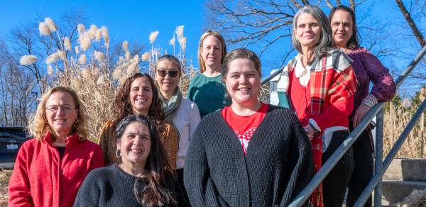 Members of the Vision Services and Education staff stand on the stairway at the Sherlock Center building.