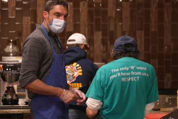 A direct support professional helps in the kitchen