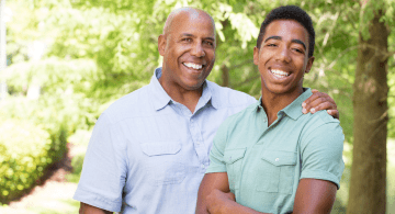 An African-American young man and his father are pictured.