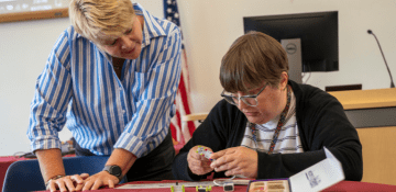 Laurie Dale helps a person build a switch.