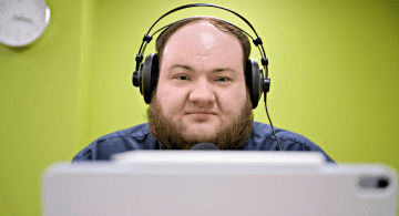 Nathan Markley wearing podcast headphones