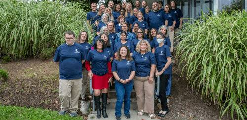 Sherlock Center staff group photo on stairs of the center