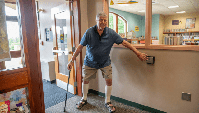A man demonstrates the automatic door at the Exeter Public Library.